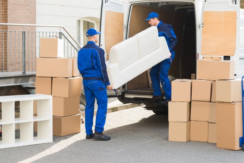 Local removals team planning a move in Brompton with packed boxes and furniture