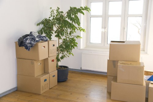 Mover wearing PPE while carrying items in a Brompton property