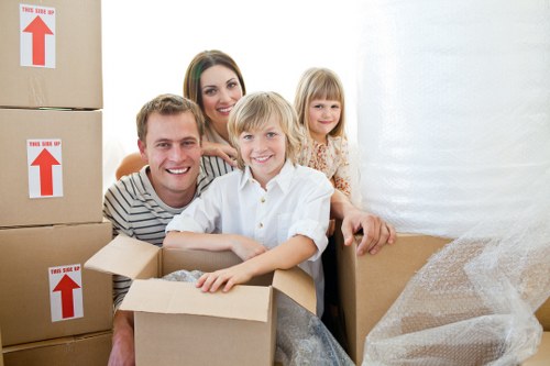 Professional movers handling boxes and furniture during a local Brompton relocation